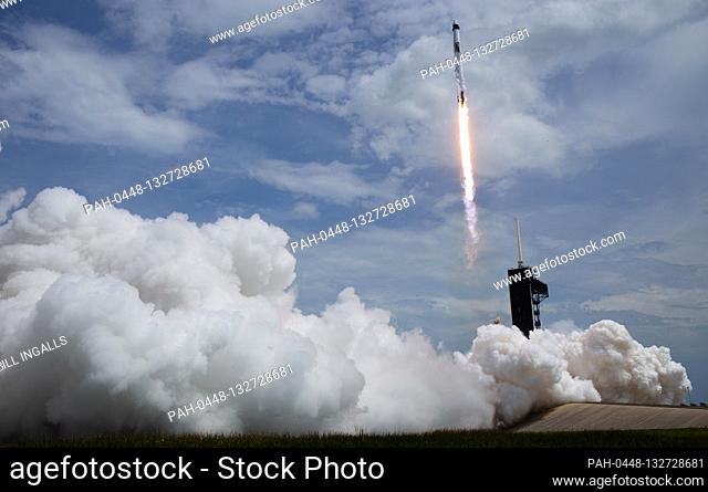 In this photo released by the National Aeronautics and Space Administration (NASA), a SpaceX Falcon 9 rocket carrying the company's Crew Dragon spacecraft is...