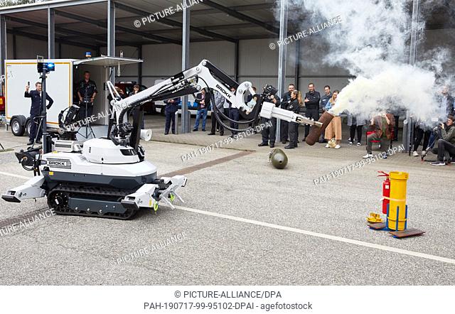 17 July 2019, Hamburg: A deactivator controls the manipulator ""Brokk 120 D"", which holds a smoking bomb dummy in the gripper arms