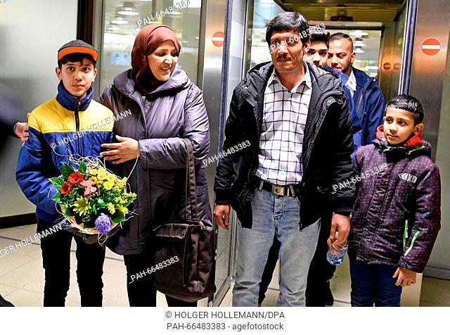 Afghan refugee boy Mahdi Rabani (L-R) stands next to his mother Shockria, his father Ibrahim and his brother Yussuf in the arrivals hall of the...