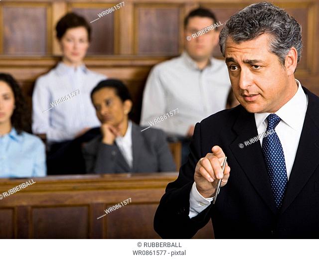 A male lawyer talking in a courtroom