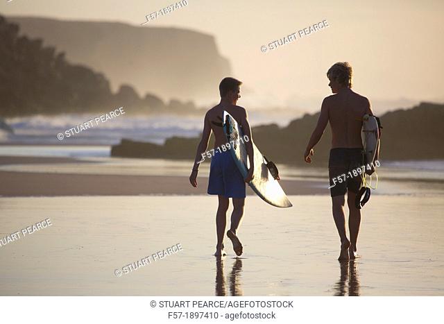 Two young surfers on Cotillo beach in Fuerteventura, Spain