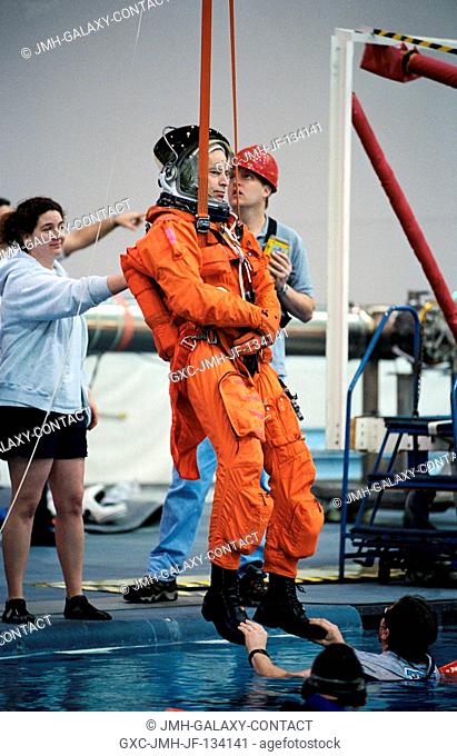 Astronaut James D. Wetherbee, STS-113 mission commander, simulates a parachute drop into water during an emergency bailout training session at the Neutral...