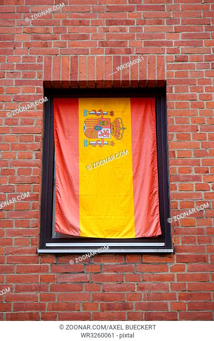 flag of spain in window of residential building
