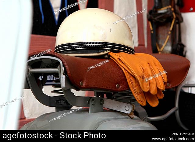 Old biker helmet and goggles with white helmet