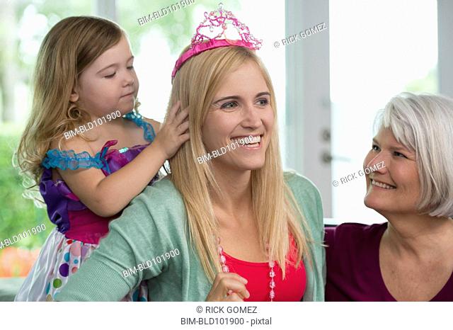 Smiling Caucasian grandmother, mother and daughter