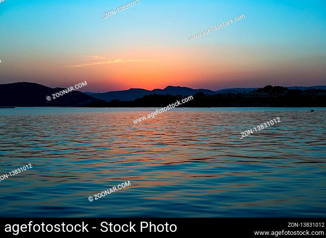 Golden Sunset on Lake Pichola in the white city of Udaipur, India