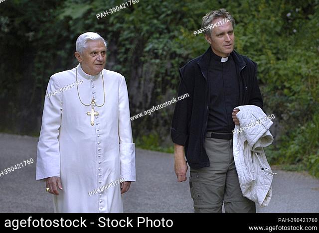 Monsignor Georg Gaenswein. photo: Pope Benedict XVI walk on the banks of a river of mountain while recitation of the Rosary