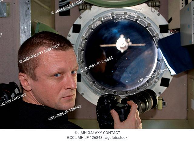 Russian cosmonaut Dmitry Kondratyev, Expedition 27 commander, is pictured near a window in the Zvezda Service Module of the International Space Station while...