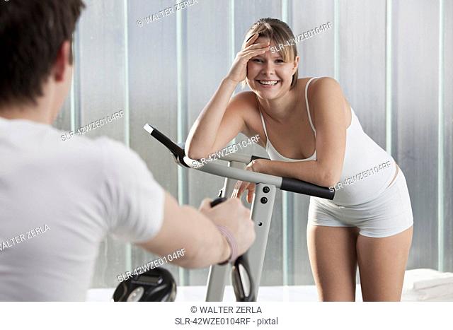 Woman laughing on exercise machine