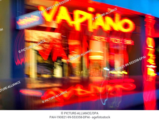 19 August 2019, Berlin: The entrance to a restaurant in the Vapiano chain (blurred by long exposure). The Cologne-based company intends to continue its...