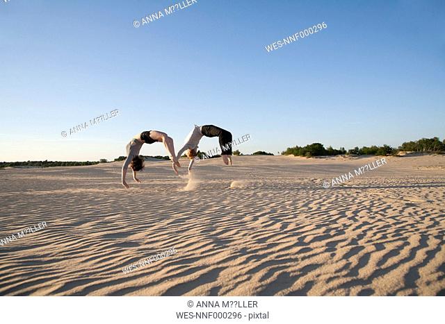 Netherlands, Acrobat couple performing sychronous backflips