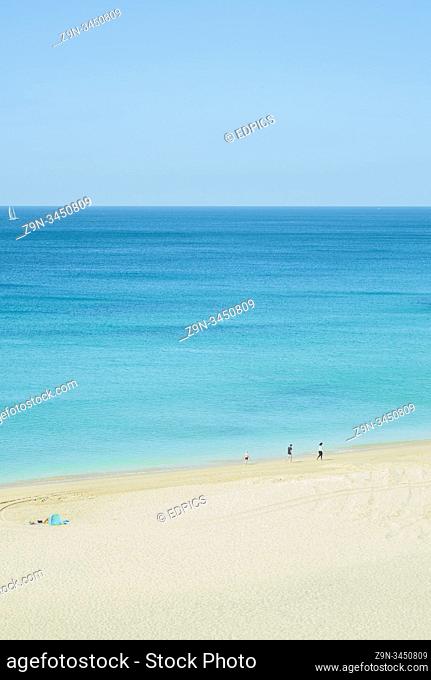 young family on deserted beach, armacao de pera, algarve, portugal
