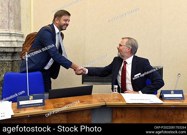 Prime Minister Petr Fiala, right, and Interior Minister Vit Rakusan shake hands during the Czech government meeting in Prague, Czech Republic, August 17, 2022