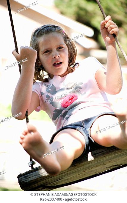 young girl swinging