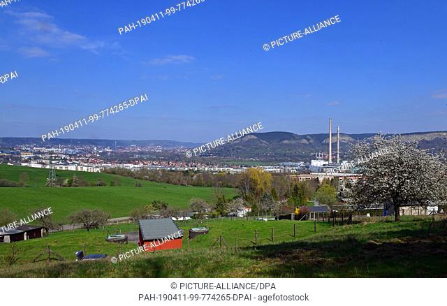 10 April 2019, Thuringia, Jena: The chimneys of the TEAG heating power plant in Jena are visible from afar. The demolition of the last large coal chimney in...