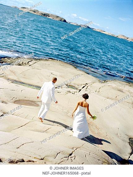 A bridal couple by the sea