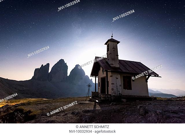 Tre Cime di Lavaredo with chapel at night, Tre Cime Natural Park, Dolomites, South Tyrol, Italy