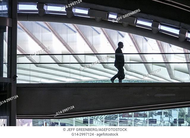 Portugal, Lisbon, Oriente, Gare do Oriente, intermodal hub, transportation, station, Santiago Calatrava, modern architecture, pedestrian bridge, man, walking