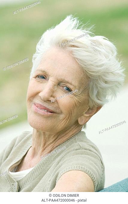 Senior woman smiling at camera, portrait