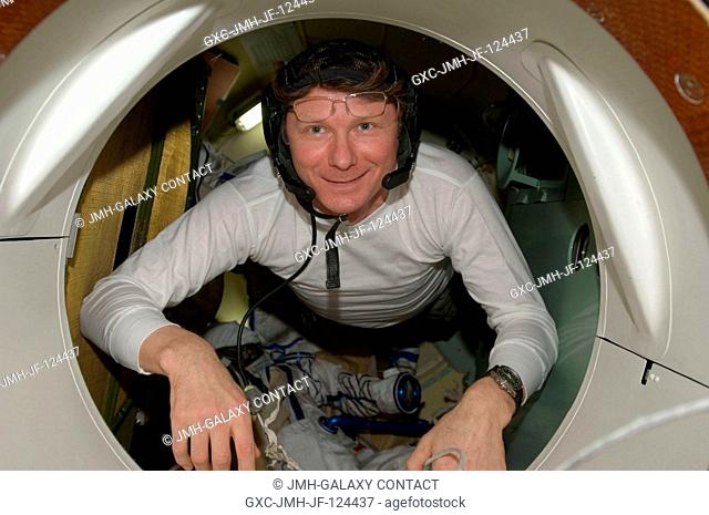 Cosmonaut Gennady Padalka, Expedition 20 commander, is pictured in a hatch on the Soyuz TMA-14 spacecraft during preparations for the relocation of the Soyuz...