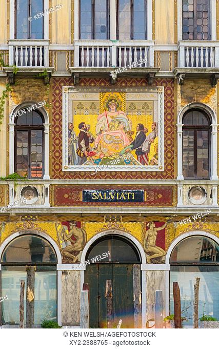 Venice, Venice Province, Veneto, Italy. The facade of the 19th century Palazzo Salviati on the Grand Canal. The mosaics advertise products created by the...
