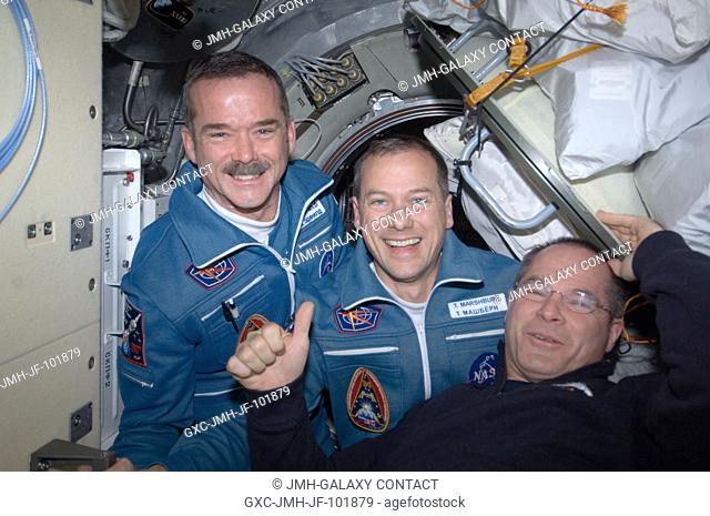 Expedition 34 Commander Kevin Ford (right) of NASA welcomes astronauts Chris Hadfield and Tom Marshburn aboard the International Space Station on docking day --...