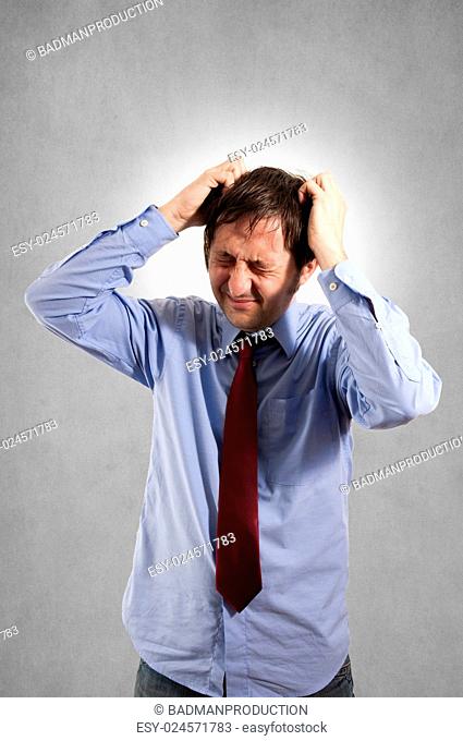 Businessman under stress on gray background