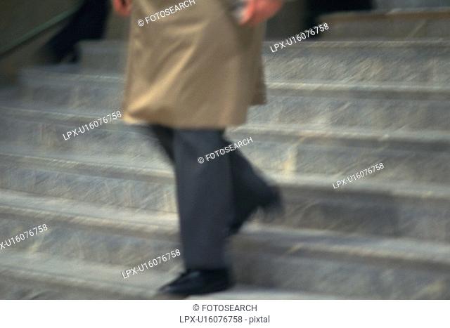 Businessman walking down the stairs, high angle view, blurred motion, New York City, NY, USA