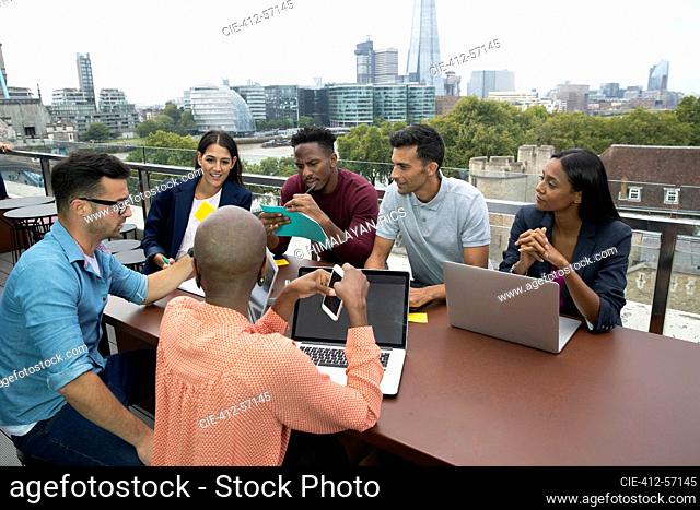 Diverse group of business people meeting on urban balcony, London, UK