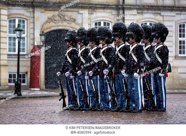 Royal Life Guards standing in snow in front of Amalienborg Palace, Copenhagen, Denmark