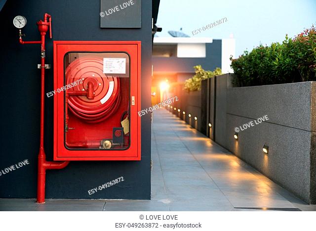 Fire extinguisher and fire hose reel in hotel corridor