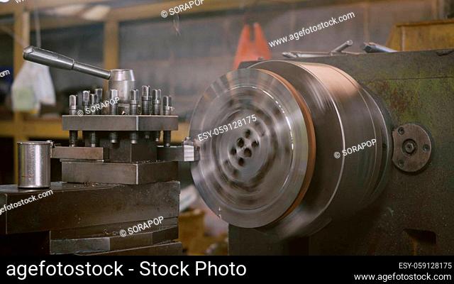 Professional machinist operating lathe grinding metal machine metalworking industrial manufacturing factory, Heavy industry lathe working, slow motion