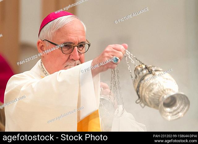 02 December 2023, Baden-Württemberg, Rottenburg am Neckar: Gebhard Fürst, Bishop of the Diocese of Rottenburg-Stuttgart, with a censer for incense at the...