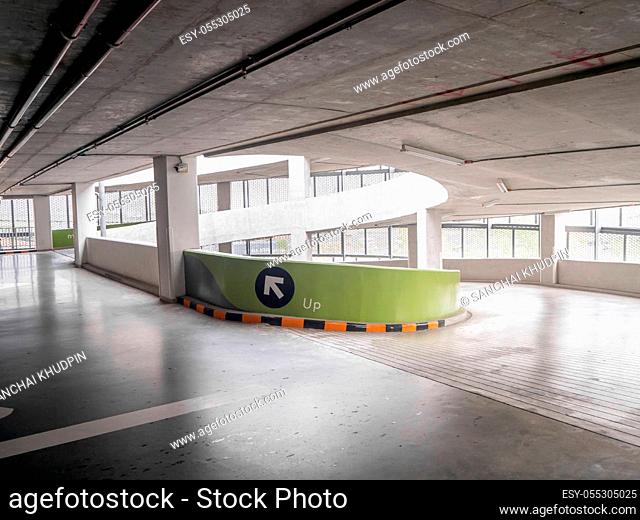 ramp of a parking structure. There is a yellow, black symbol. This image is the parking lot of the department store