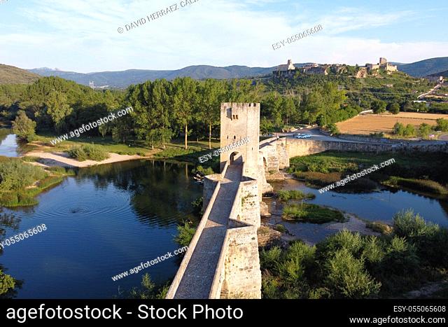 Aerial view of a medieval stone bridge over Ebro river in Frias, historic village in the province of Burgos, Spain. High quality 4k footage