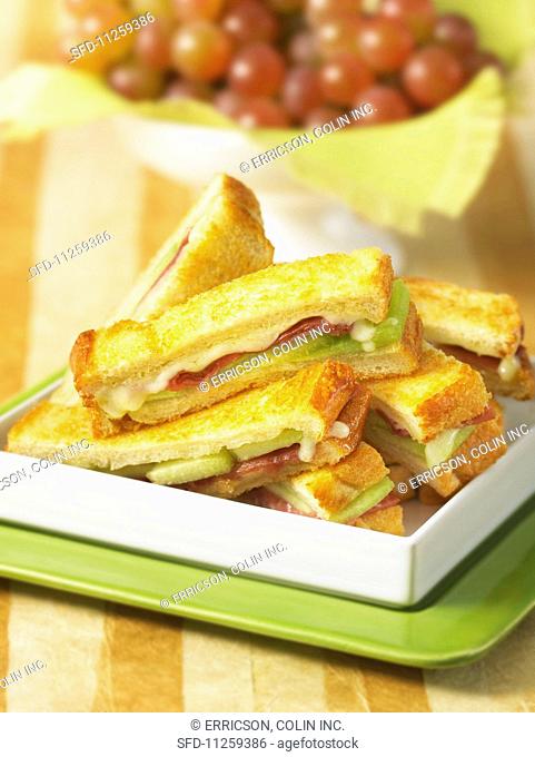 Toasted finger sandwiches with prosciutto, melon and grilled cheese