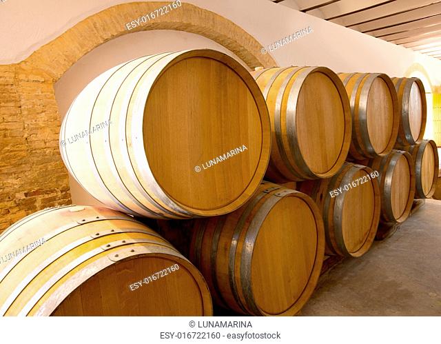 wine wooden oak barrels stacked in a row at Mediterranean winery
