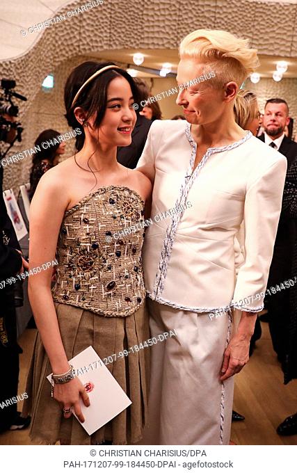 Actresses Nana Ouyang and Tilda Swinton (R) pose together at the Elbe Philarmonic Hall prior to Karl Lagerfeld's fashion show in Hamburg, 6 December 2017