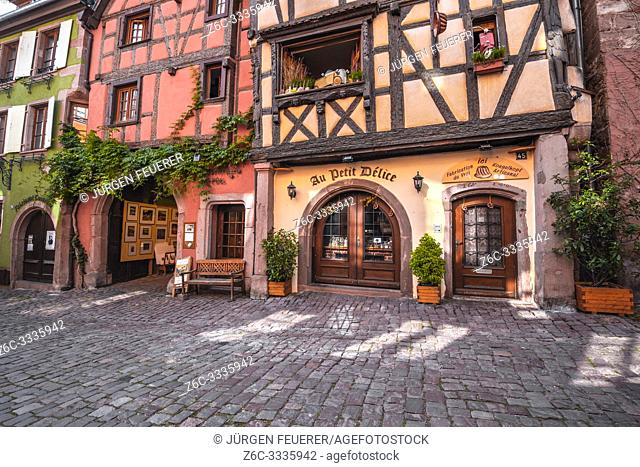 old timbered houses with carvings in the village Riquewihr, Alsace, France, typic Alsatien tourist destination