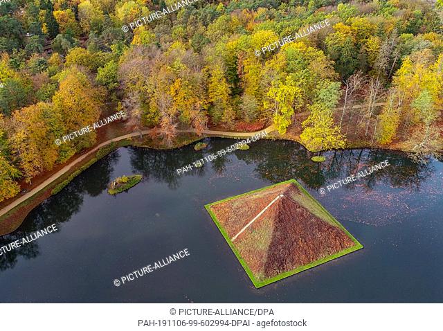 06 November 2019, Brandenburg, Cottbus: The pyramid of the lake in the Fürst-Pückler-Park of Branitz (aerial photograph with a drone)