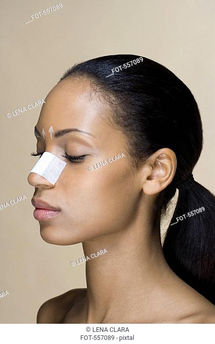 Portrait of a woman with her nose bandaged