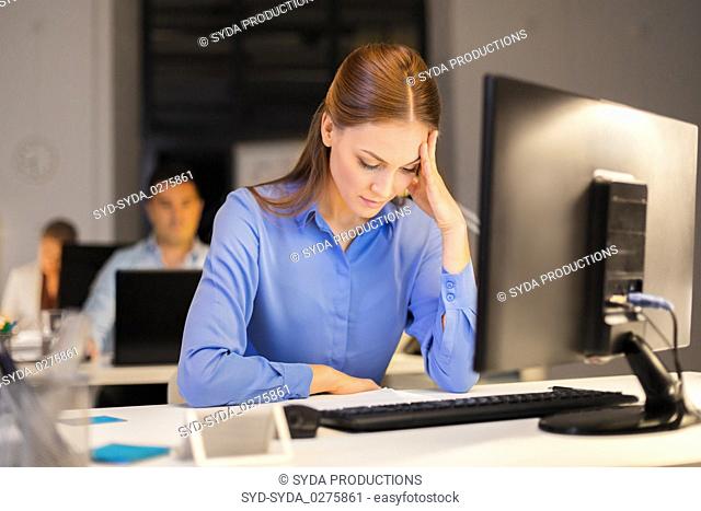 businesswoman with computer at night office