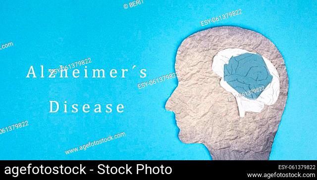 Alzheimer disease is standing on a paper, silhouette of a head with a damaged brain, dementia diagnosis, Parkinson's awareness day Sprache für Stichwörter:...