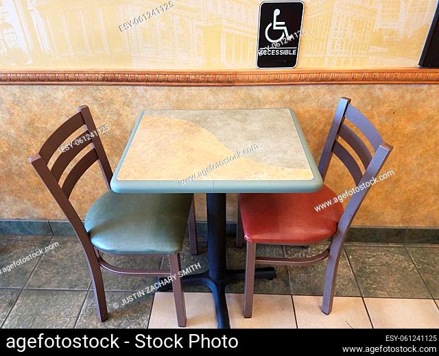 accessible or wheelchair sign near table with blue and red chain