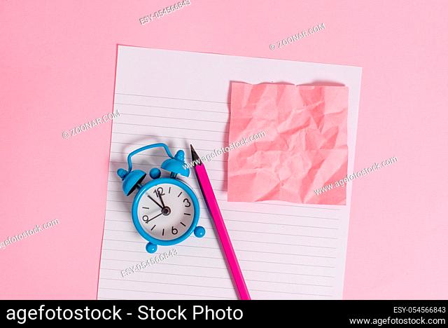 Striped paper sheet note pencil vintage alarm clock colored background