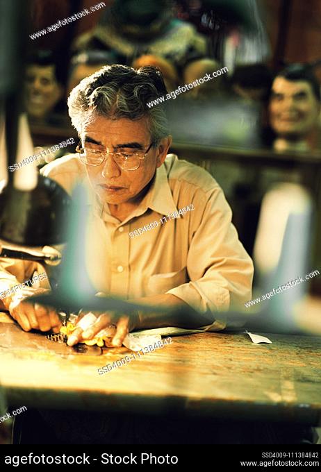 Senior man working at workshop table