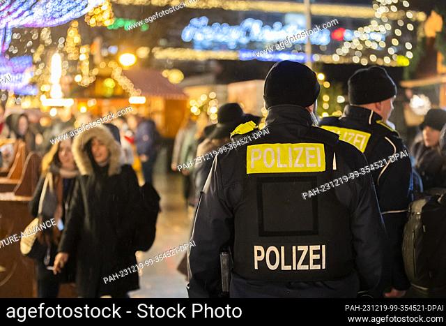 19 December 2023, Berlin: Police officers patrol the Christmas market on Breitscheidplatz. This is where 13 people were killed in an Islamist terrorist attack...