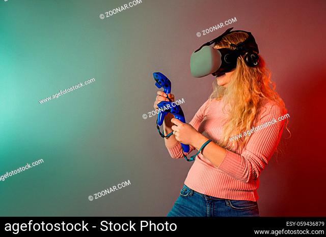 Woman using a gaming gadget for virtual reality. Augmented reality in gaming