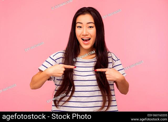 Wow, this is me, Amazed attractive girl with long hair pointing herself and looking with surprised expression, proud of own success, self-love concept