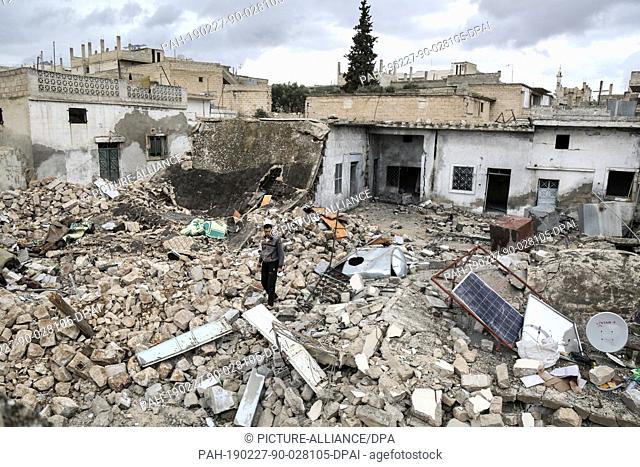 27 February 2019, Syria, Khan Sheikhun: A man inspects the damage of the buildings of the town of Khan Sheikhun after a reported shelling by the Syrian...